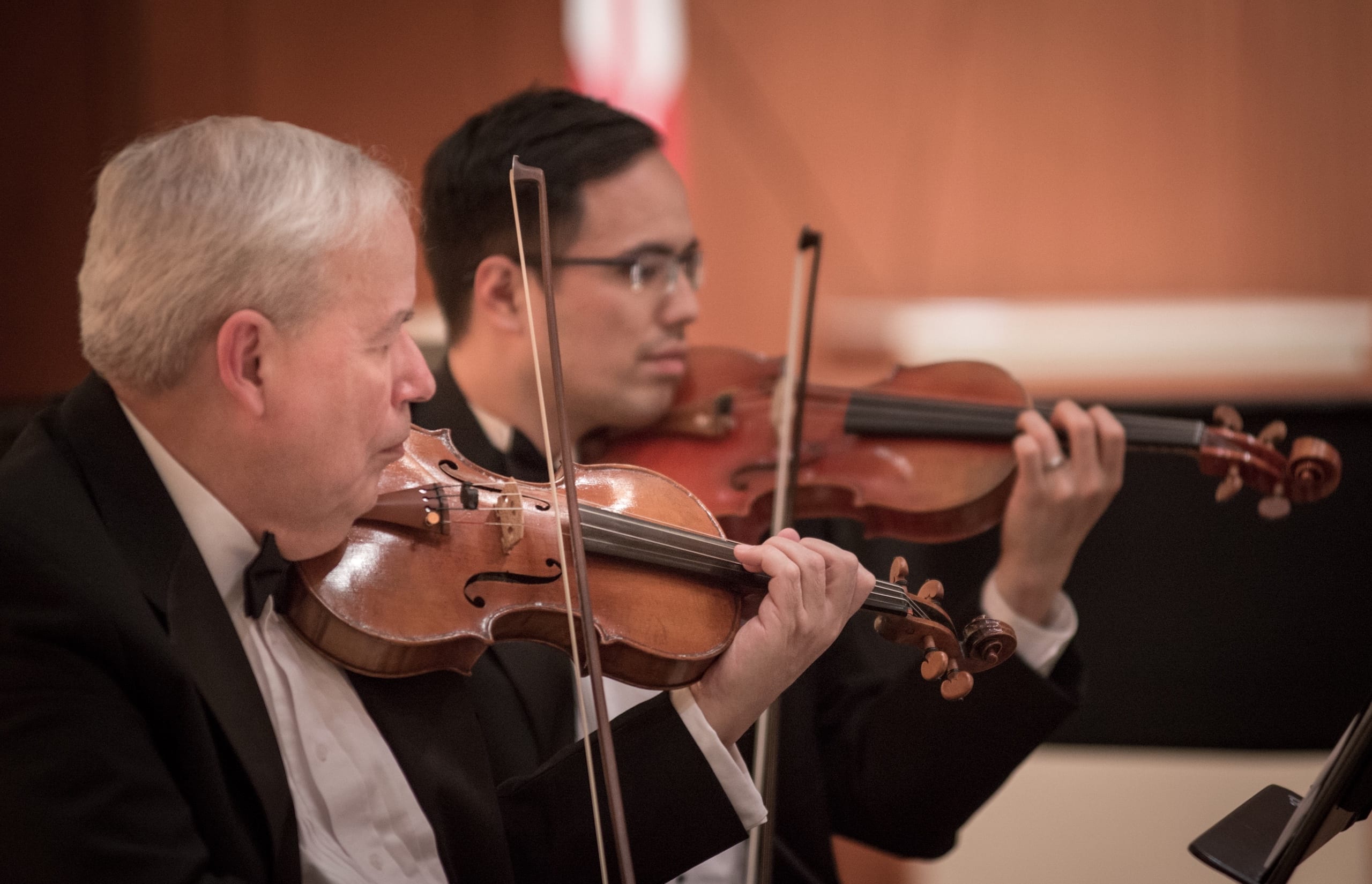 Photograph of the first violin section.